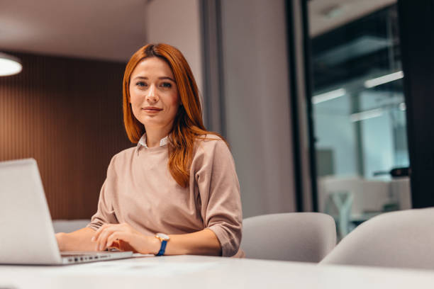 istock Focused businesswoman working on laptop in modern office 2196764677