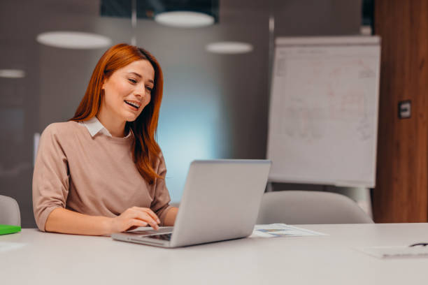 istock Focused businesswoman working on laptop in modern office 2196764705