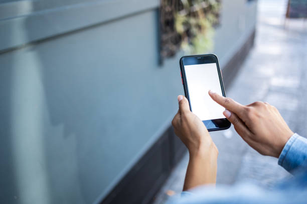 istock Over the shoulder view of a woman using mobile phone 2196765198
