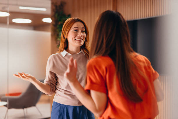 istock Two businesswomen discussing in modern office during a break 2196765357