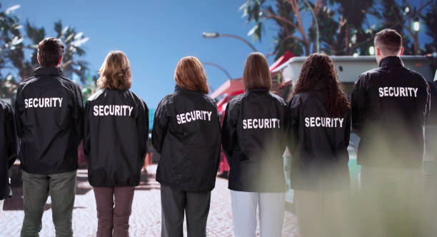 istock African American security officer walks with his diverse team 2196768361