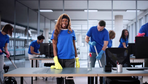 istock Young African American Janitor Smiling while Cleaning an Office 2196768447