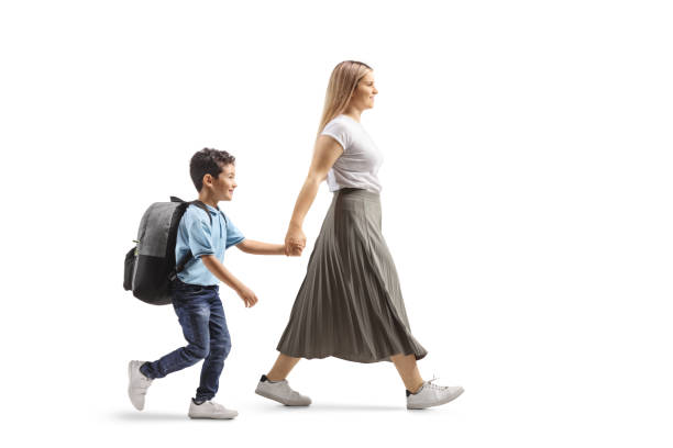 istock Mother holding hands with son and walking 2196768575