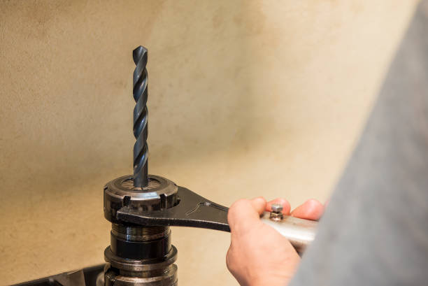 istock The worker tighten the drill tool to the holder. 2196769857