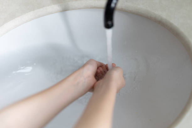 Only One School Boy washes hands in the bathroom. House interior. Cracow in Poland.