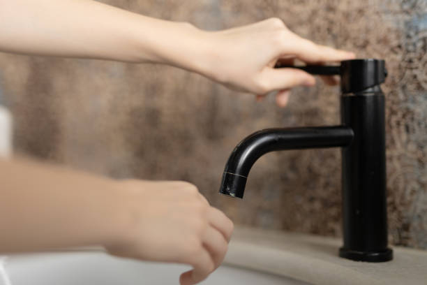 istock Young boy washes his hands in the bathroom 2196770239