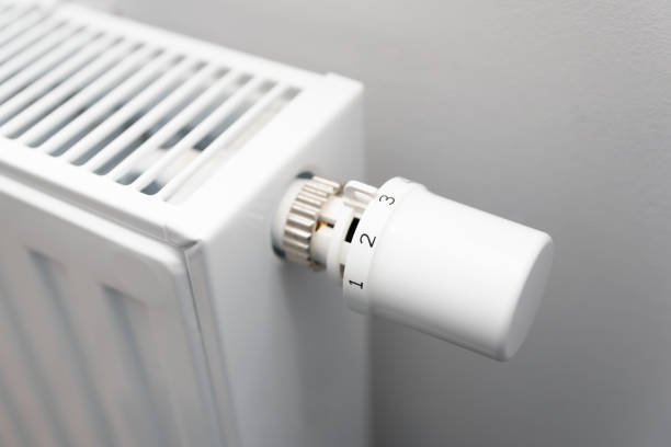 istock Person is adjusting the temperature on a radiator 2196770896