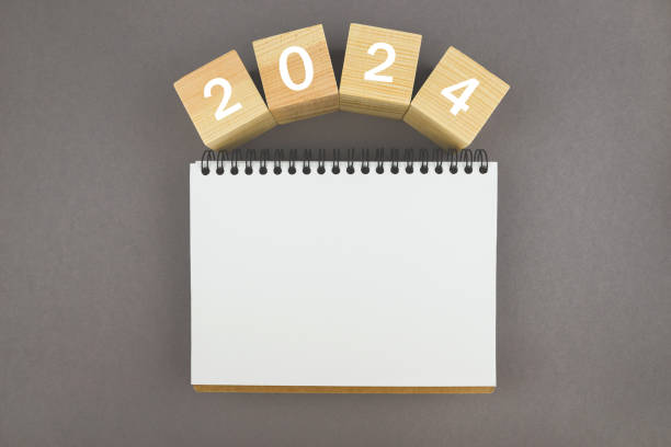 istock 2024 on cubes with a blank notepad on a gray background for your text. Calendar or layout. New Year concept, resolution, goal, plan, health. copy space 2196770925