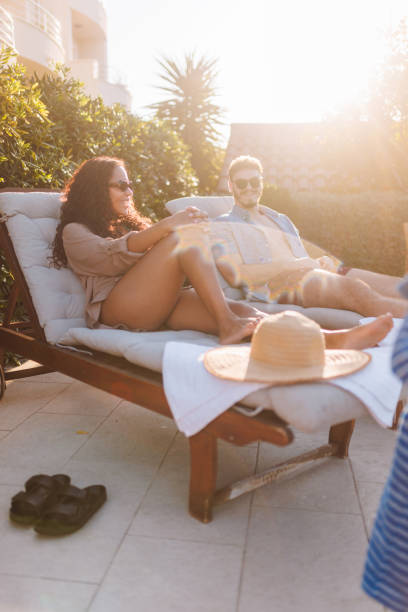 istock Couple Relaxing Poolside at Luxury Resort 2196773212