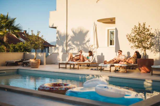 istock Diverse Friends Relaxing Poolside at a Luxurious Resort 2196773256