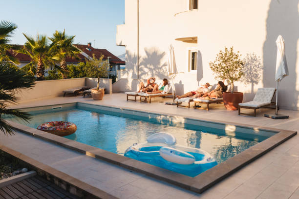 istock Friends Relaxing by the Pool in Sunny Resort 2196773263