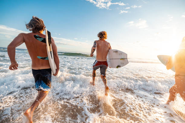 istock Surfers Running into Waves on Gold Coast Beach at Sunrise 2196773382
