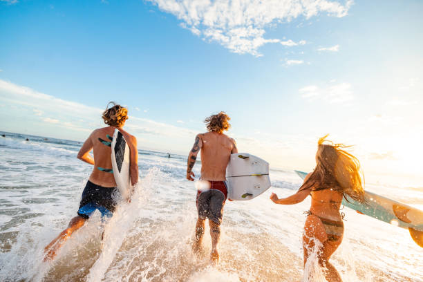 istock Young White Adults Surfing at Sunrise on Gold Coast Beach 2196773391
