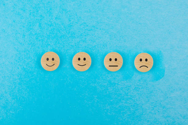istock Wooden blocks with happy smile face symbol on blue background, evaluation, ranking increase, customer service quality, satisfaction and best ranking concept 2196774428