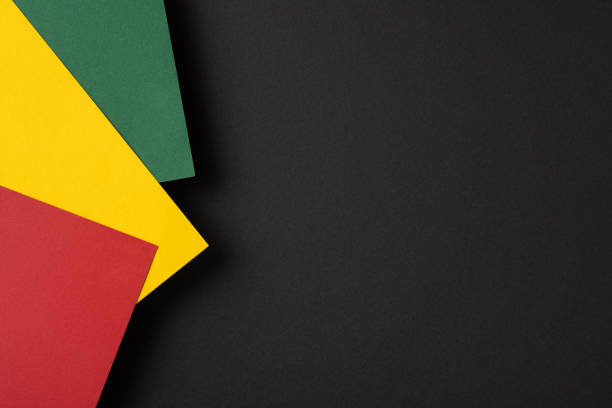 istock Brightly colored red, yellow, and green paper sheets arranged against a dark background forming a vibrant contrast, ideal for designs expressing creativity, cultural identity 2196774614
