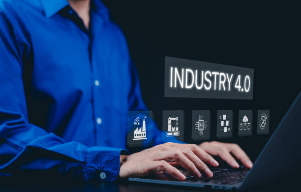istock Smart industry 4.0 and factory automation concept. A person using a laptop with interface 