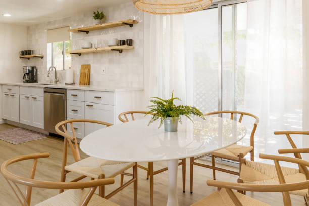 istock Minimalist Kitchen and Dining Area with White Cabinets and Light Wood Chairs 2196777177