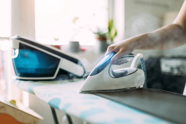 istock Ironing Clothes with Moden Steam Iron in Bright Daylight at Home 2196777747