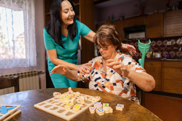 istock Nurse Assisting Elderly Woman in Letter Sorting Task 2196777914