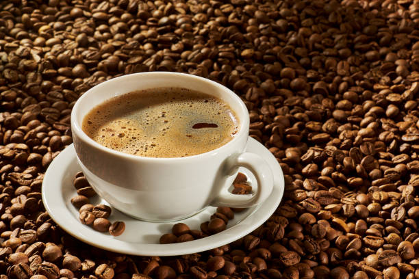 istock Cup of coffee on a background of roasted beans 2196780026