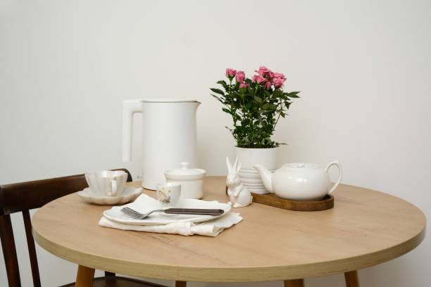 istock A beautifully serene dining table setting features an elegant flower pot, a lovely tea set, creating a cozy ambiance for easter. 2196780247