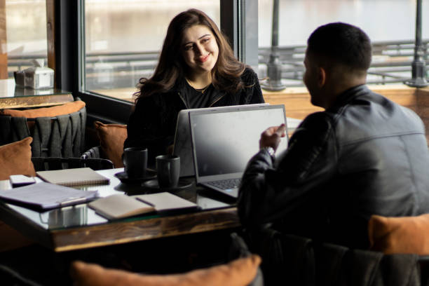 istock Happy remote professionals collaborating on a project in a cafe. 2196780451