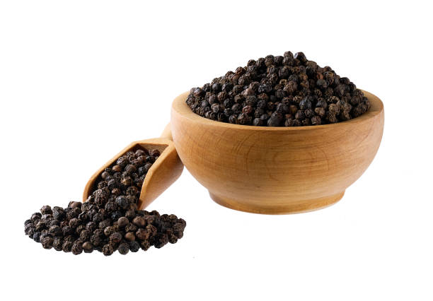 istock black pepper seeds in a wooden bowl isolated on white background. 2196780792