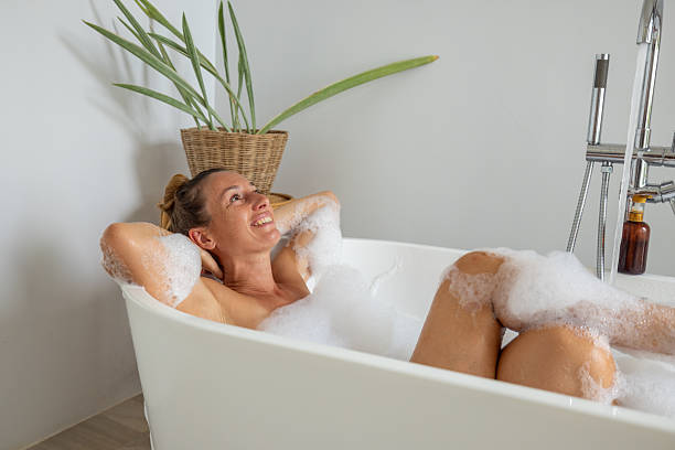 istock Relaxed woman enjoying a bubble bath at home 2196781973