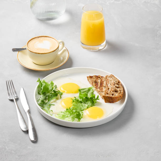 istock Minimalist Breakfast Sunny-Side Up Eggs with Toast on Subtle Gray Background 2196782359