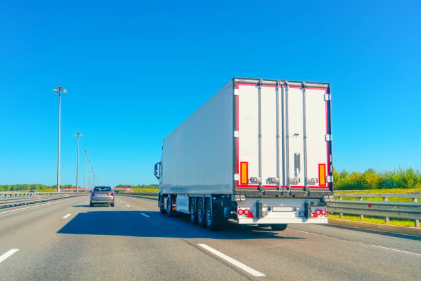 istock A large truck is seen driving on a sunny highway, surrounded by a pristine clear blue sky, creating a picturesque travel scene that showcases nature 2196785484