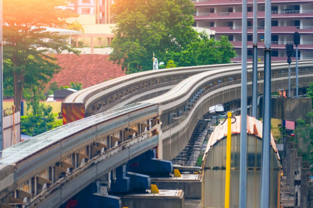 istock Switching change transition move direction track Inscription - Danger high voltage. Modern mass transit. Rail transportation. Driverless straddle monorail on concrete guideway beam conductor rail. 2196785832