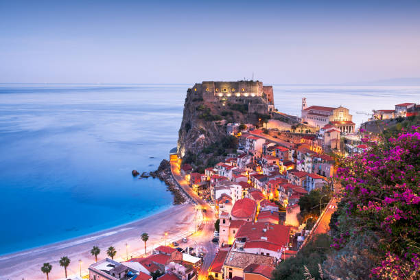 Scilla, Italy on the Mediterranean at Dawn Scilla, Italy on the Mediterranean coast at twilight with seasonal flowers. castle scilla stock pictures, royalty-free photos & images