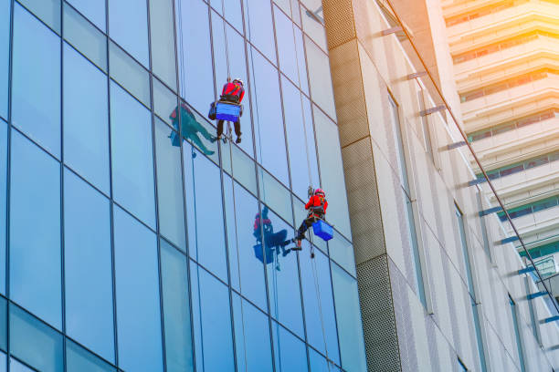 istock Work on the heights. Industrial mountaineering, group of workers cleaning windows service on high rise building. 2196785887
