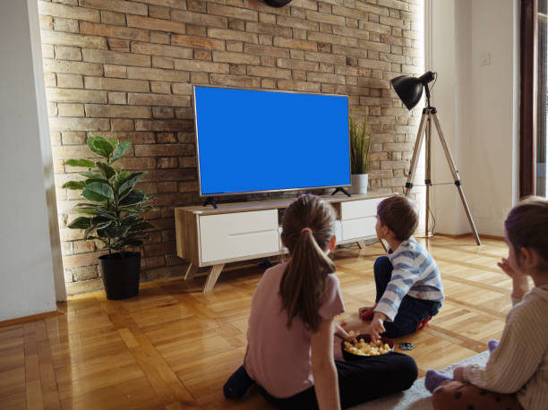istock Siblings watching TV at home 2196785924
