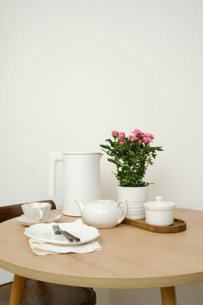 istock A beautifully serene dining table setting features an elegant flower pot, a lovely tea set, creating a cozy ambiance. 2196786254