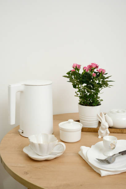 istock A beautifully serene dining table setting features an elegant flower pot, a lovely tea set, creating a cozy ambiance for easter. 2196786578