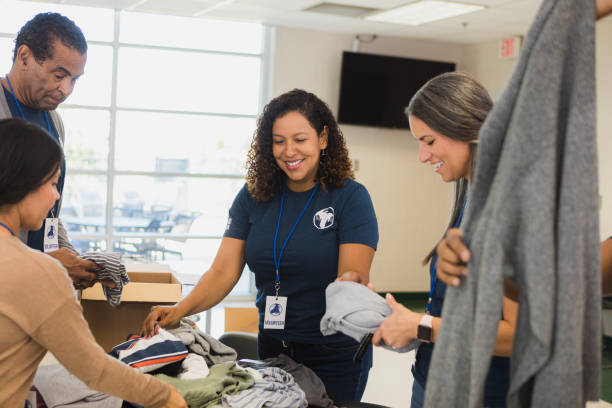 istock Volunteers sorting clothing donations at a community center 2196786735