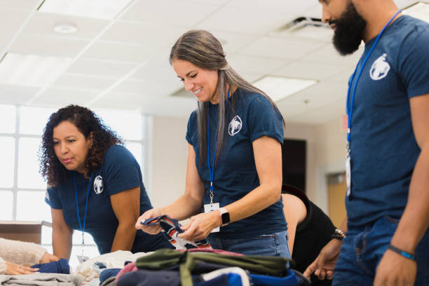 istock Volunteers Sorting Donations at a Charity Event 2196786739