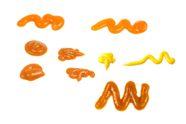 istock Orange sauce splashes isolated on white background 2196789034