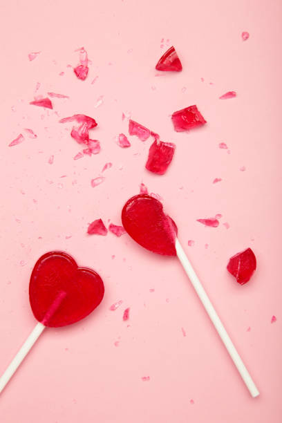 istock Broken heart lollipop on pink background. 2196789293