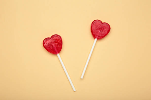 istock Sweet heart shaped lollipops on beige background. Valentine's day celebration 2196789679