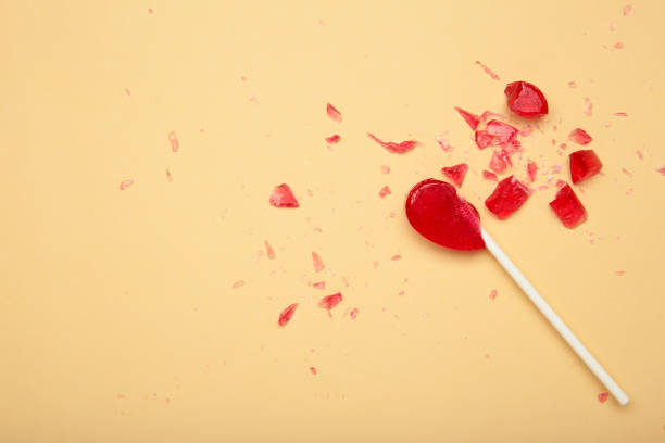istock Broken heart lollipop on beige background. 2196789820
