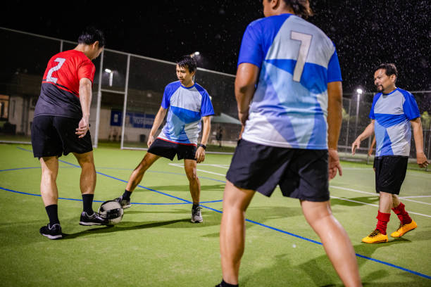 istock Men playing soccer at night in Sydney, showcasing teamwork and dynamic action in a recreational match 2196791831