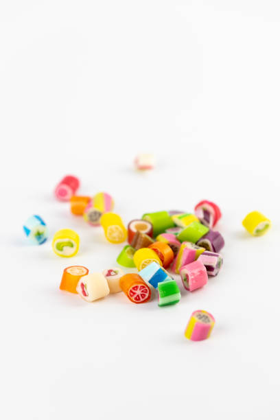 istock on white background in a small multi-colored sugar caramels with different flavors and patterns lie children's favorite sweets a large selection risk of caries blood sugar excess weight 2196792939
