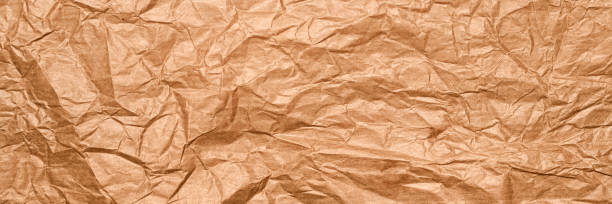 A seamless crumpled brown paper texture ideal for background use, perfect for creative multimedia projects, vintage aesthetics, or craft-themed stock photo
