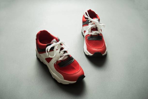 istock A pair of red and white sneakers on a gray background 2196794193