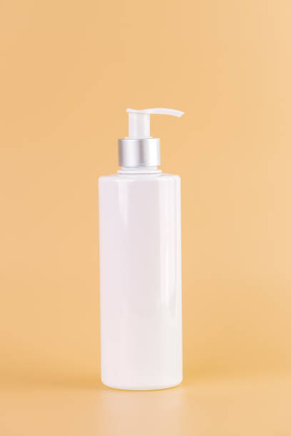 istock close-up on a soft yellow background white glossy bottle with dispenser minimalist container for cosmetics beauty industry hermetic storage of liquids 2196794887
