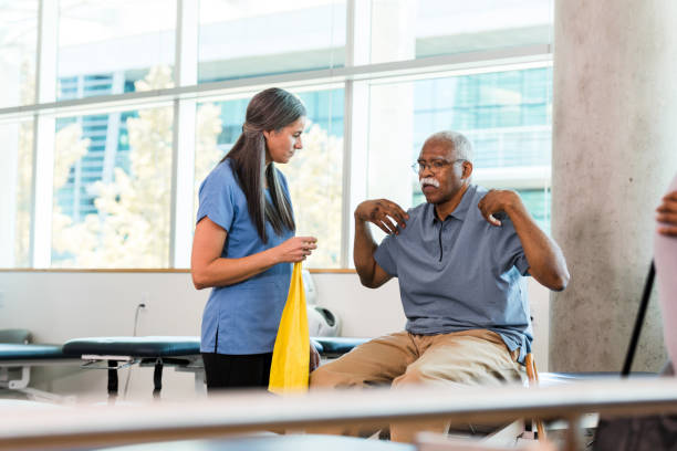 istock Physical Therapist Assisting Senior Man with Exercise 2196795025
