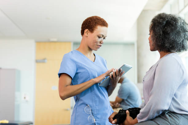 istock Healthcare Professional Using Tablet with Patient 2196795058