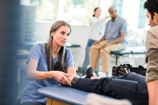 istock Physical Therapist Examining Patient's Foot in Clinic 2196795077